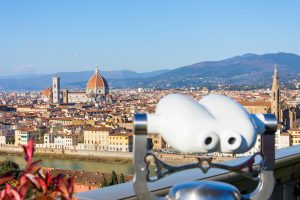 Binoculars on the observation deck in the Piazzale Michelangelo. Florence Italy at sunny day cityscape aerial view.