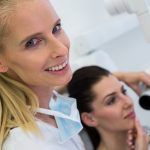 Dentist taking a female patients tooth x-ray in clinic