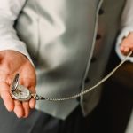 Old pocket watch in the hands of a man